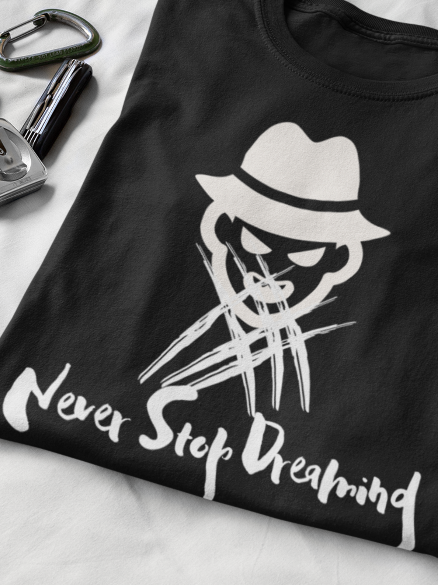 Comfortable Halloween unisex tee with Freddy Kruegar that states 'Never Stop Dreaming' in color black