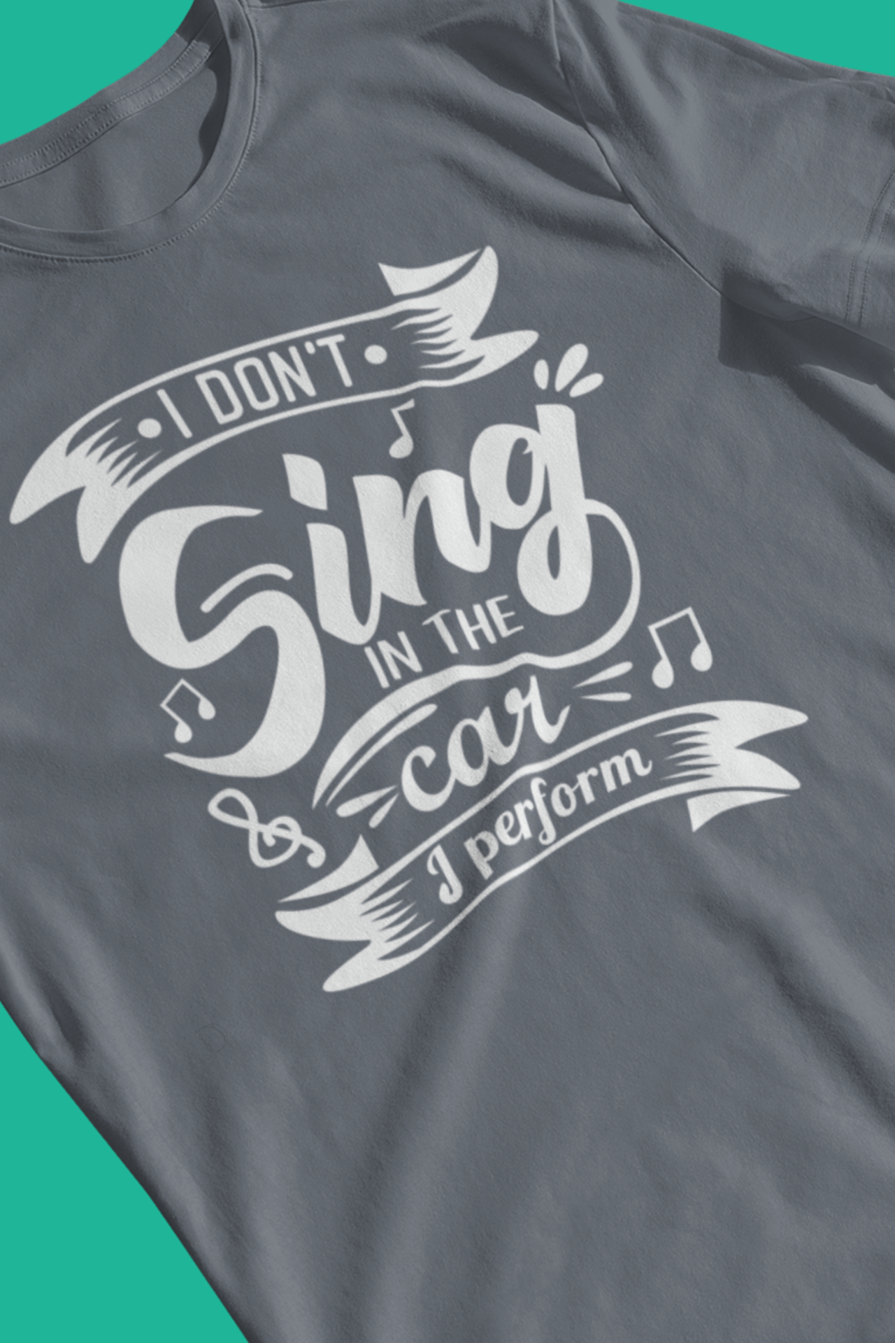 Graphic tee stating 'I Don't Sing in the Car, I perform' in color steel blue