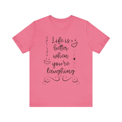 graphic t-shirt stating 'Life is better when you're laughing' in color charity pink