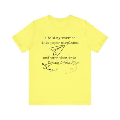 Women's adult humor t-shirt stating 'i fold my worries into paper airplanes and turn them into flying fucks' in color yellow