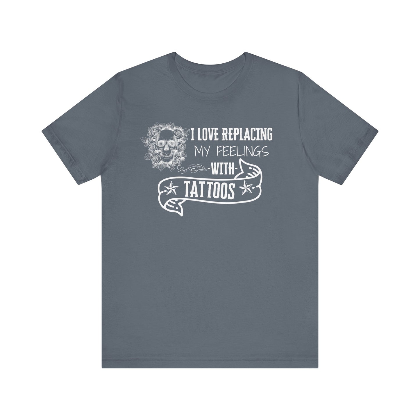 A sarcastic graphic tee stating 'I love replacing my feelings with tattoos' in color steel blue