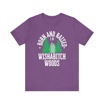 Comfortable adult humor tee stating Born and Raised in Wishab*tch Woods in color purple heather