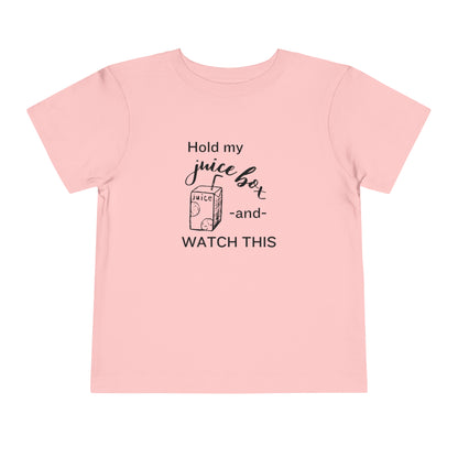 Comfortable funny graphic toddler tee stating 'Hold my juice box and watch this' in color pink