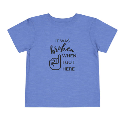 Comfortable funny graphic toddler tee stating 'It was broken when I got here' in color heather columbia blue