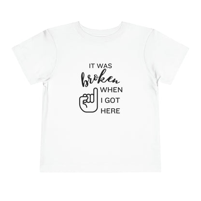 Comfortable funny graphic toddler tee stating 'It was broken when I got here' in color white