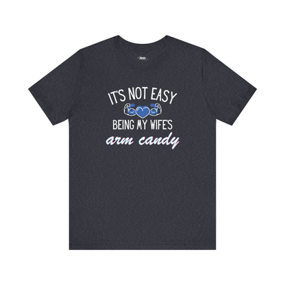 Graphic tee stating It's Not Easy Being My Wife's Arm Candy in color navy heather