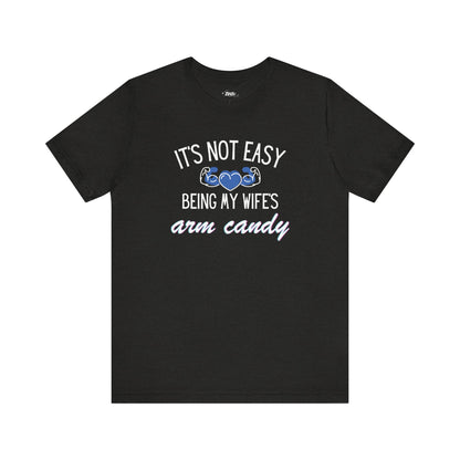 Graphic tee stating It's Not Easy Being My Wife's Arm Candy in color dark grey