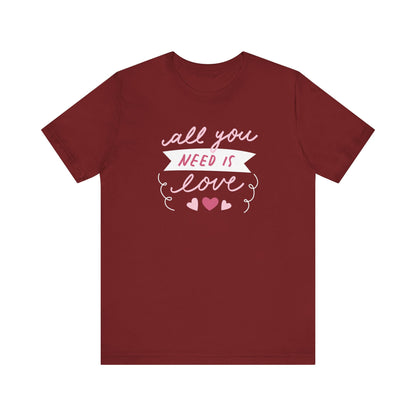 Comfortable Women's Graphic Tee Stating 'All You Need Is Love' in color maroon