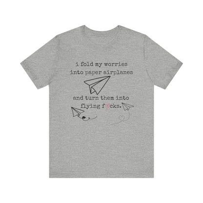 Women's adult humor t-shirt stating 'i fold my worries into paper airplanes and turn them into flying fucks' in color athletic heather