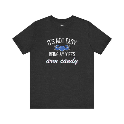Graphic tee stating It's Not Easy Being My Wife's Arm Candy in color dark grey heather