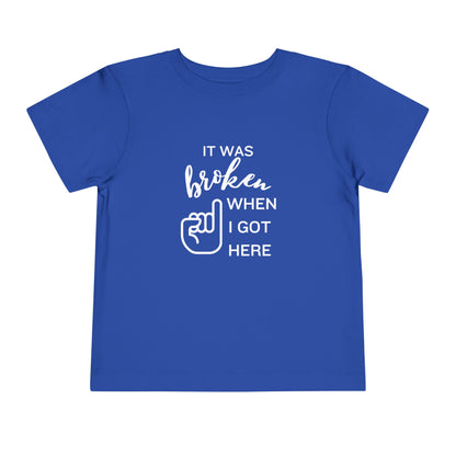 Comfortable funny graphic toddler tee stating 'It was broken when I got here' in color true royal