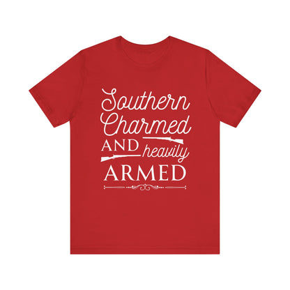 Adult unisex t-shirt stating 'Southern Charmed and Heavily Armed' in color red