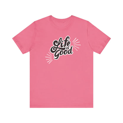 Folded cotton shirt stating 'Life is Good' in color charity pink