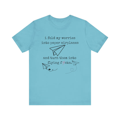 Women's adult humor t-shirt stating 'i fold my worries into paper airplanes and turn them into flying fucks' in color turquoise