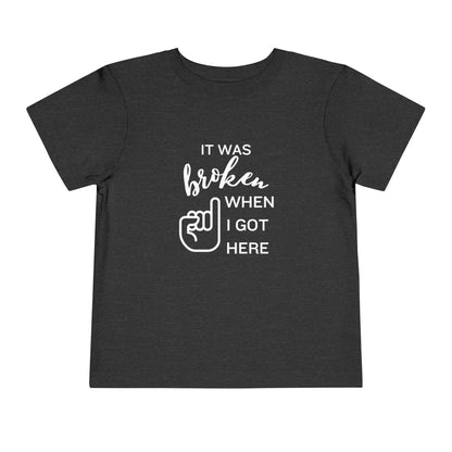 Comfortable funny graphic toddler tee stating 'It was broken when I got here' in color dark grey heather