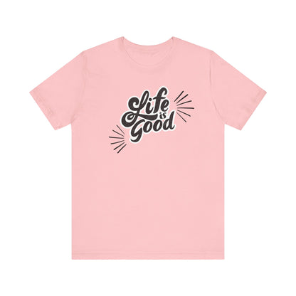 Folded cotton shirt stating 'Life is Good' in color pink