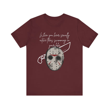 Unisex Comfortable Halloween tee with Jason mask that says 'When you hear sexually active teens swimming in your lake' in color maroon