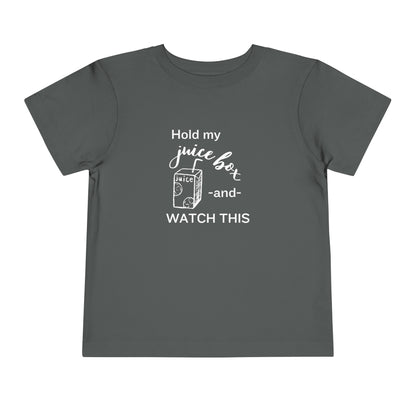 Comfortable funny graphic toddler tee stating 'Hold my juice box and watch this' in color asphalt