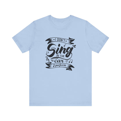 Graphic tee stating 'I Don't Sing in the Car, I perform' in color baby blue