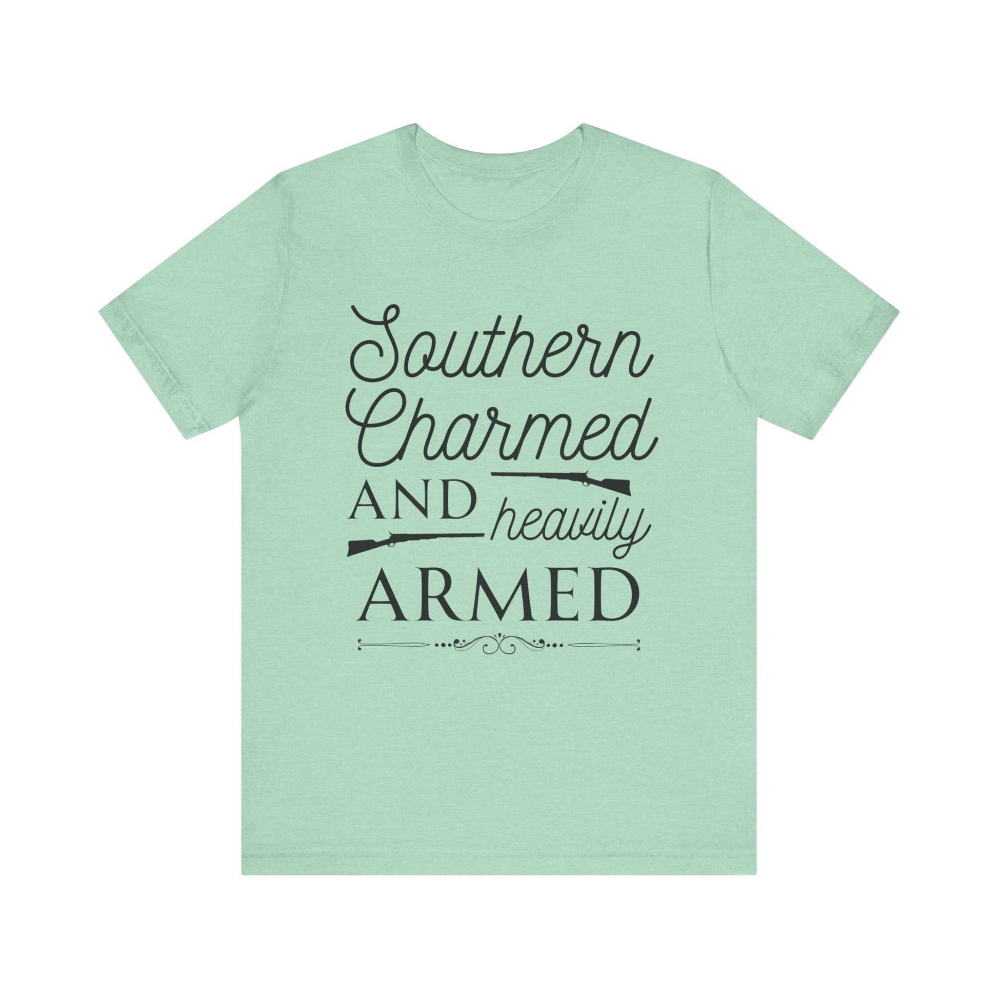 Adult unisex t-shirt stating 'Southern Charmed and Heavily Armed' in color mint heather