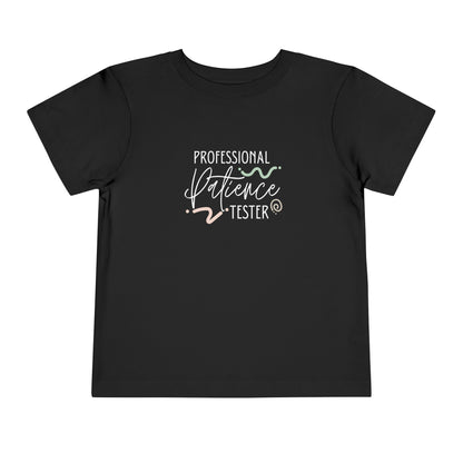 Comfortable funny graphic toddler tee stating 'Professional Patience Tester' in color  black
