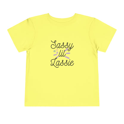 Comfortable funny graphic toddler tee stating 'Sassy Lil Lassie' in color  yellow