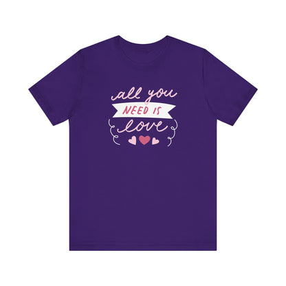 Comfortable Women's Graphic Tee Stating 'All You Need Is Love' in color purple