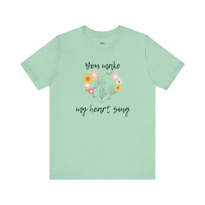 Adult graphic tee stating 'You Make My Heart Sing' in color mint heather