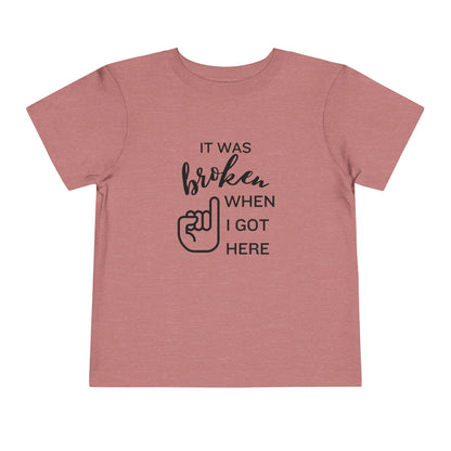 Comfortable funny graphic toddler tee stating 'It was broken when I got here' in color heather mauve