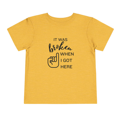 Comfortable funny graphic toddler tee stating 'It was broken when I got here' in color golden yellow heather