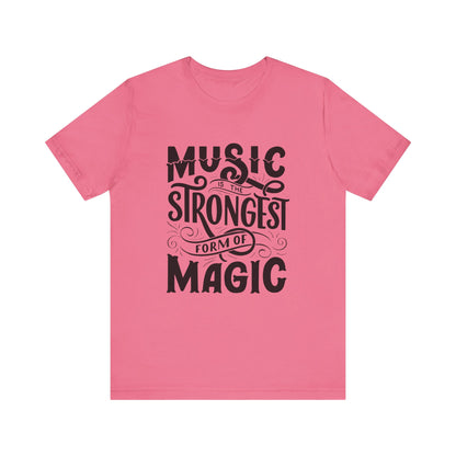 A comfortable good vibes tee stating 'Music is the strongest form of magic' in color charity pink