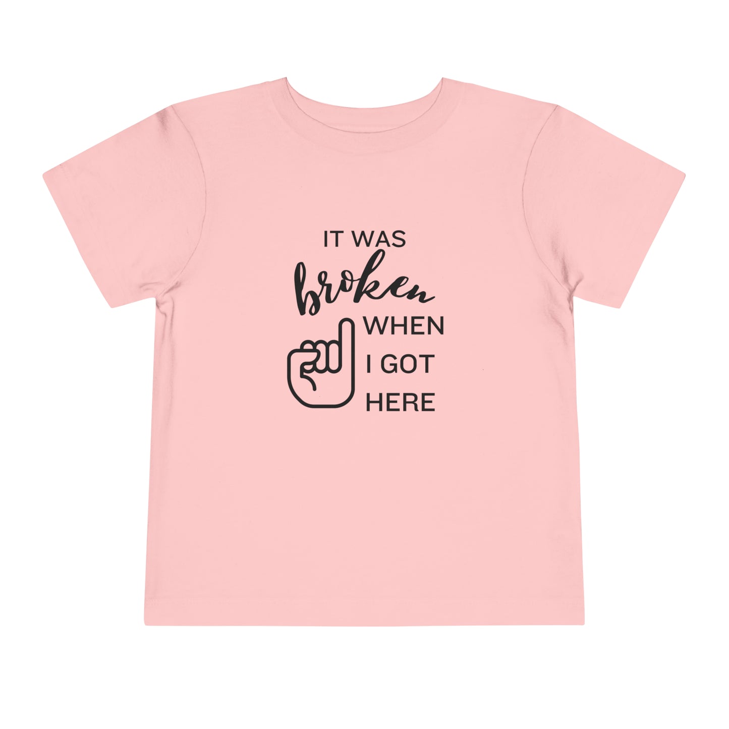 Comfortable funny graphic toddler tee stating 'It was broken when I got here' in color pink