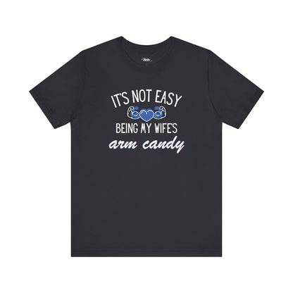 Graphic tee stating It's Not Easy Being My Wife's Arm Candy in color dark grey