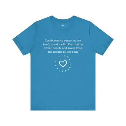 Comfortable good vibes graphic t-shirt stating 'She dances to songs in her head, speaks with the rhythm of her heart, and loves from the depths of her soul' in color aqua