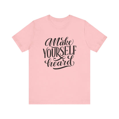 Good vibes graphic tee stating 'Make Yourself Heard' in color pink
