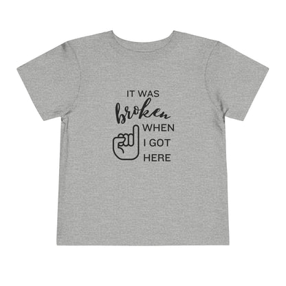 Comfortable funny graphic toddler tee stating 'It was broken when I got here' in color athletic heather