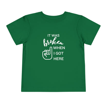 Comfortable funny graphic toddler tee stating 'It was broken when I got here' in color kelly