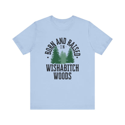 Comfortable adult humor tee stating Born and Raised in Wishab*tch Woods in color light blue