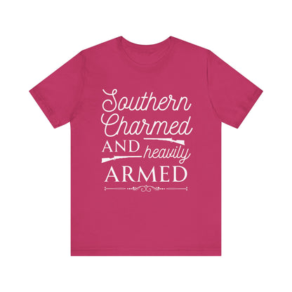 Adult unisex t-shirt stating 'Southern Charmed and Heavily Armed' in color berry