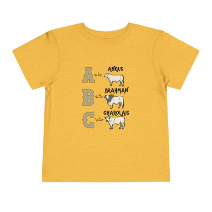 Comfy southern toddler tee stating 'A is for Angus. B is for Brahman. C is for Charolais.' in color heather yellow gold