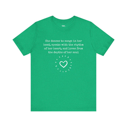 Comfortable good vibes graphic t-shirt stating 'She dances to songs in her head, speaks with the rhythm of her heart, and loves from the depths of her soul' in color kelly