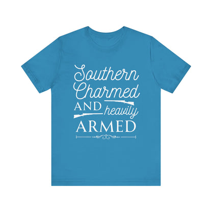 Adult unisex t-shirt stating 'Southern Charmed and Heavily Armed' in color aqua