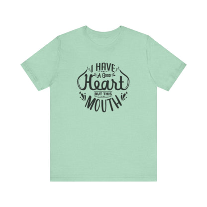 Graphic tee stating 'I have a good heart, but this mouth' in color mint heather