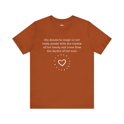 Comfortable good vibes graphic t-shirt stating 'She dances to songs in her head, speaks with the rhythm of her heart, and loves from the depths of her soul' in color autumn