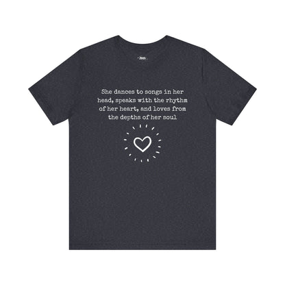 Comfortable good vibes graphic t-shirt stating 'She dances to songs in her head, speaks with the rhythm of her heart, and loves from the depths of her soul' in color navy heather