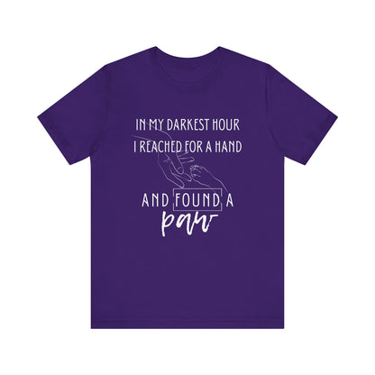 Comfortable graphic tee stating 'In my darkest hour I reached for a hand and found a paw' in color purple