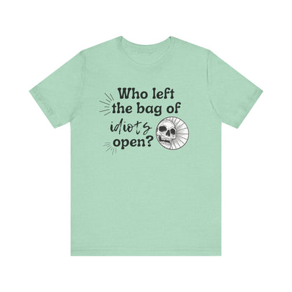 Unisex graphic tee stating 'Who left the bag of idiots open?' in color mint heather
