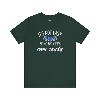 Graphic tee stating It's Not Easy Being My Wife's Arm Candy in color forest