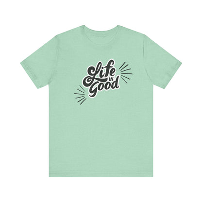 Folded cotton shirt stating 'Life is Good' in color mint heather