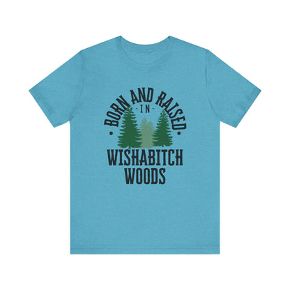Comfortable adult humor tee stating Born and Raised in Wishab*tch Woods in color aqua heather